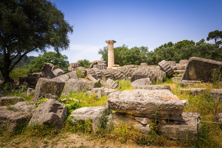 Ruins surround a lone pillar.