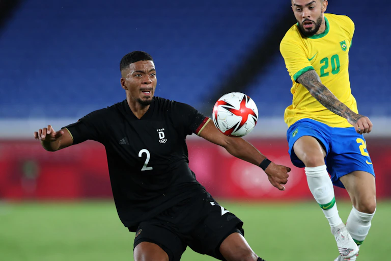 male soccer player stares at the ball in the air
