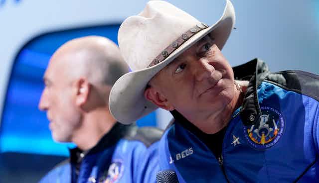 A man in a cowboy hat wearing a space suit.