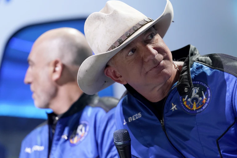 A man in a cowboy hat wearing a space suit.