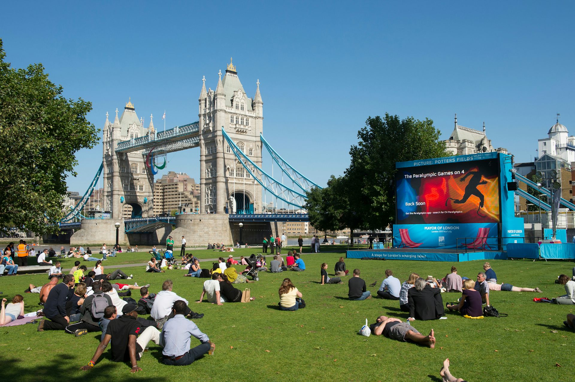 Crowds watching the 2012 London Olympics on a large screen by Tower Bridge, London, England
