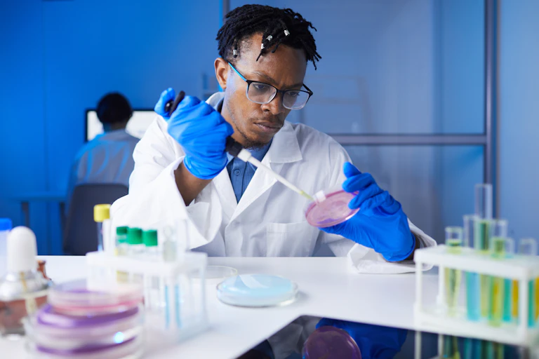 Man wearing a lab coat and working in a laboratory