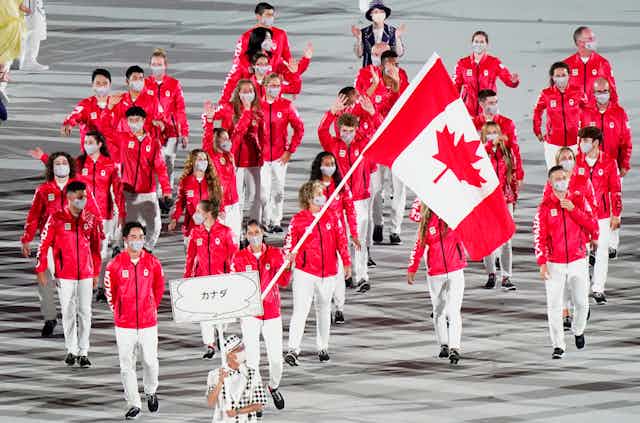 A small group of Canadian athletes march in the opening ceremonies.