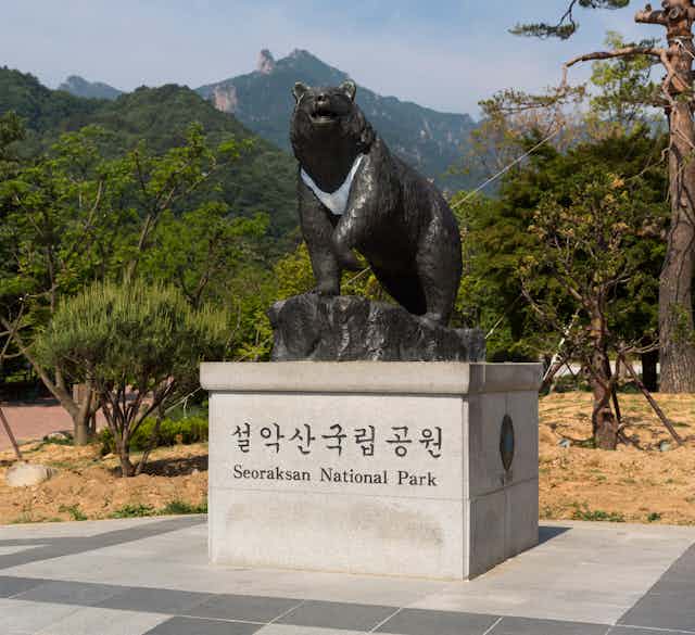 A statue of a black bear outside a South Korean national park.