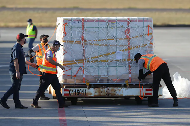 A shipment of CoronaVac vaccines being unloaded in El Salvador