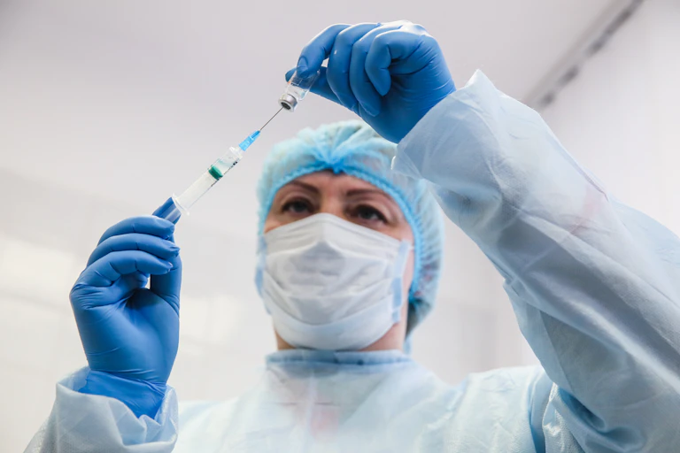 A Ukrainian nurse fills a syringe with the CoronaVac vaccine