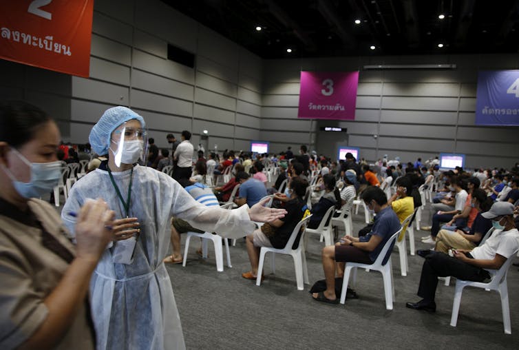People waiting to be vaccinated at a vaccine centre in Bangkok, Thailand