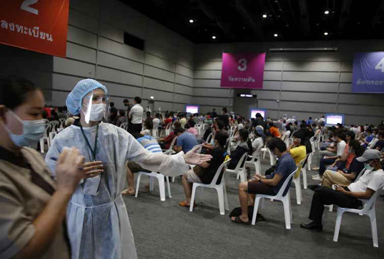 People waiting to be vaccinated at a vaccine centre in Bangkok, Thailand