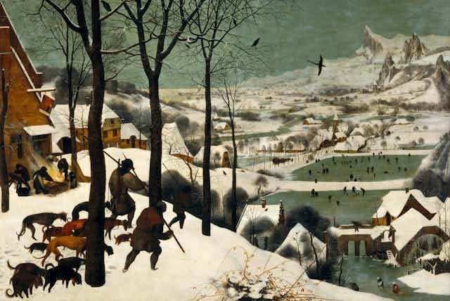 Historic painting of hunters with dogs walking over a snowy hillside toward a town where people are skating on a frozen river