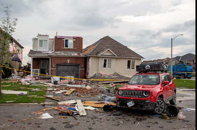A photo of a front yard showing tornado damage