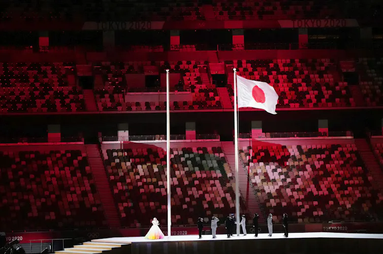 The flag is raised in-front of empty seats.
