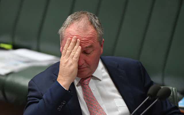 Nationals leader Barnaby Joyce puts his hand on his forehead in federal parliament 