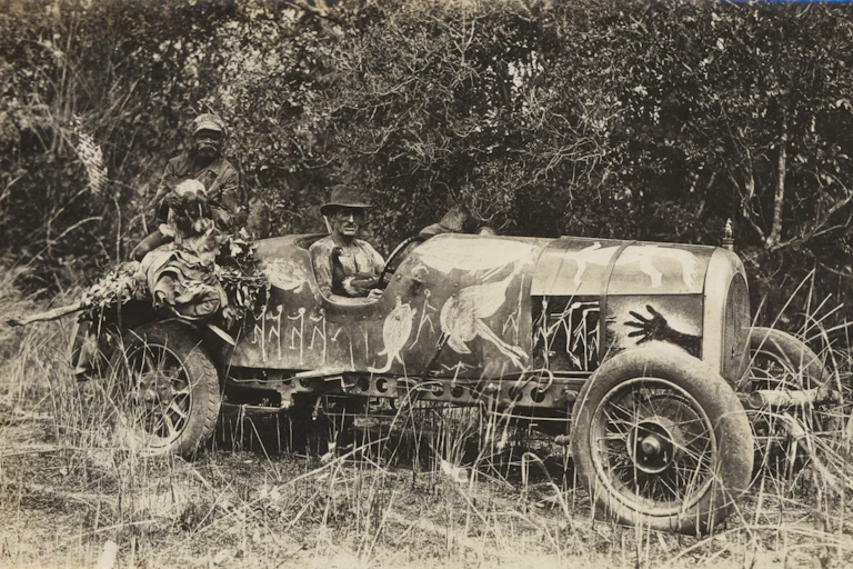 two men pose with car