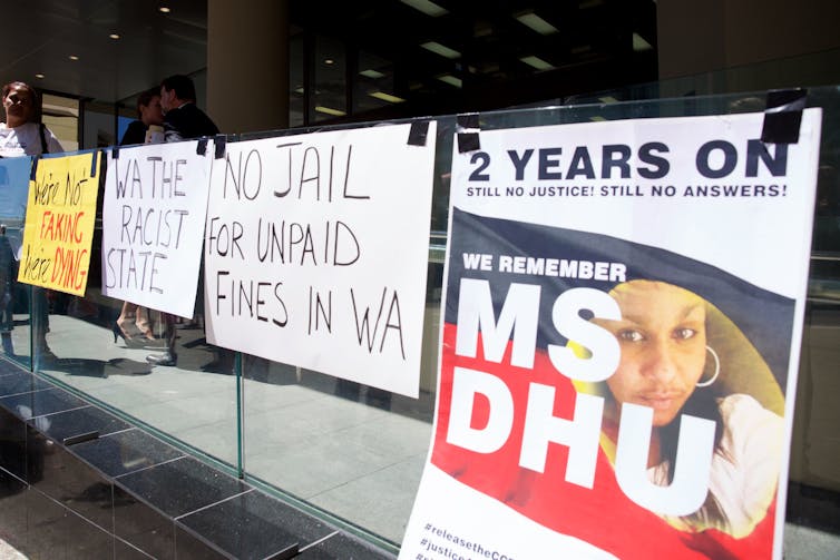 Signs put up by supporter of Ms Dhu outside the coroner's court in Perth.