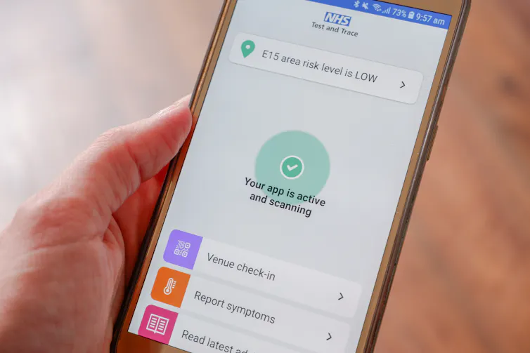 Photo of a mobile phone screen showing the NHS track and trace app scanning location