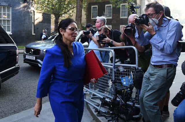 Home Secretary Priti Patel walks into Downing Street past a group of photographers