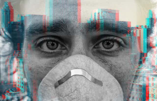 Double exposure of person wearing face mask and city buildings