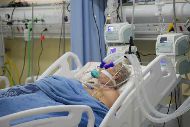 patient in hospital bed on respirator