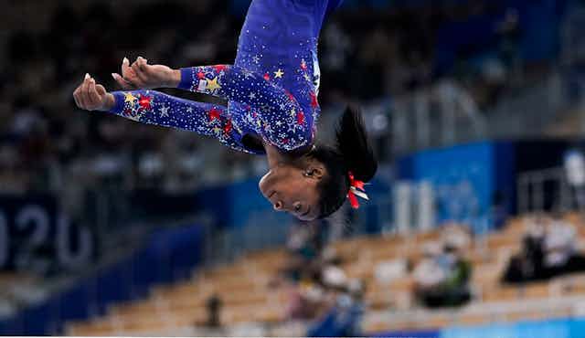 Gymnast Simone Biles midway through a somersault