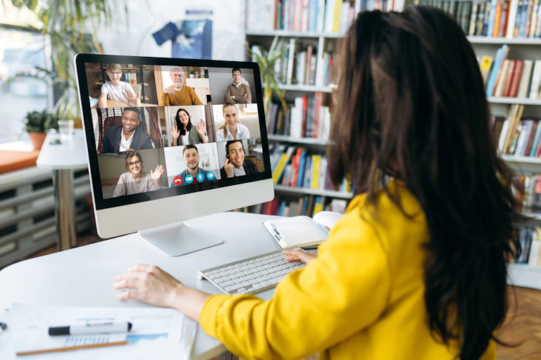 Women sitting at laptop chatting with other participants online