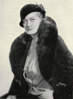 Black and white picture of a woman in a fur coat.