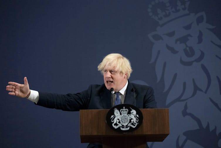 Boris Johnson making a speech at a podium