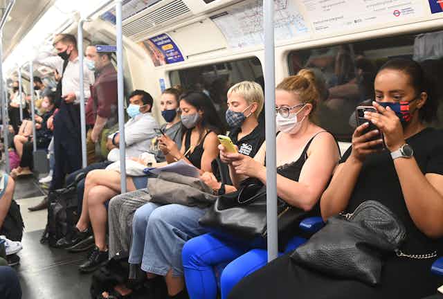Commuters wearing masks on the London Underground