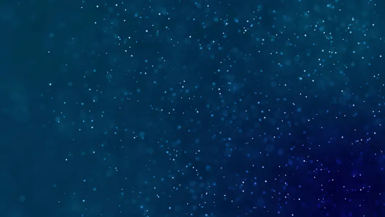 Blue ocean water background with dust particles flickering within