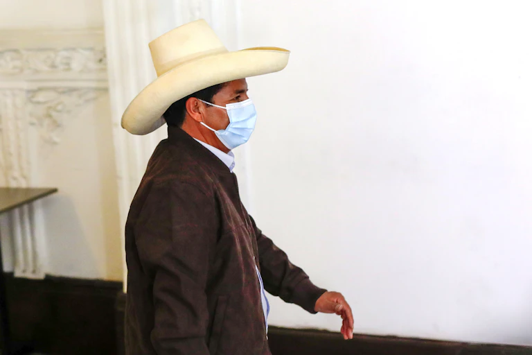 Castillo walks in hat and face mask