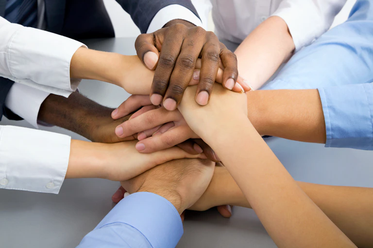 Hands clasped in a circle.