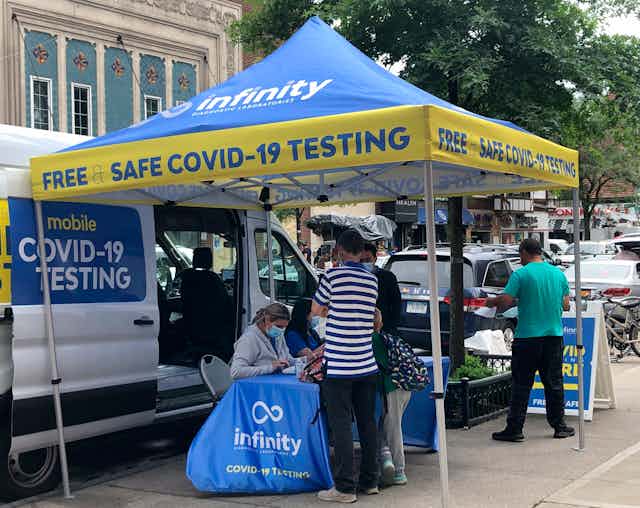 people at a mobile COVID-19 testing site