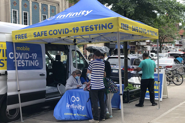 people at a mobile COVID-19 testing site