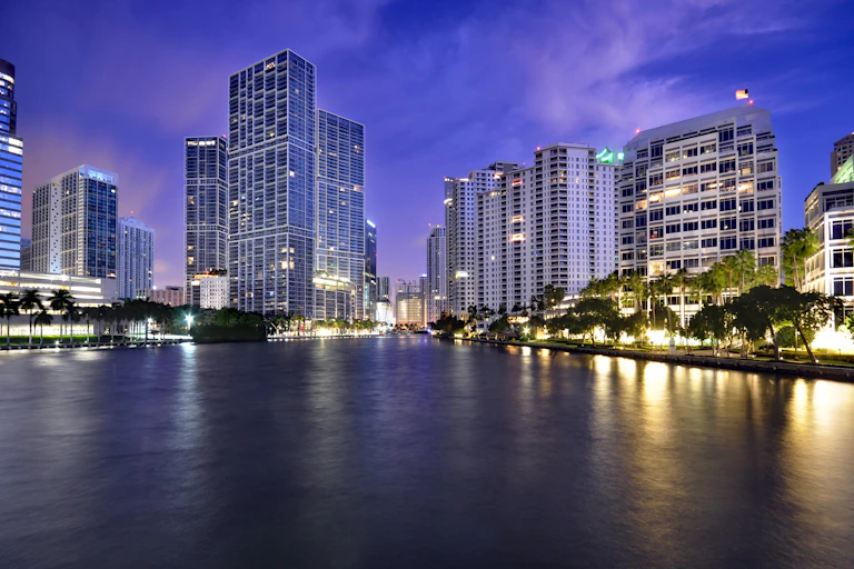 Dusk view of Miami towers along a bay and river
