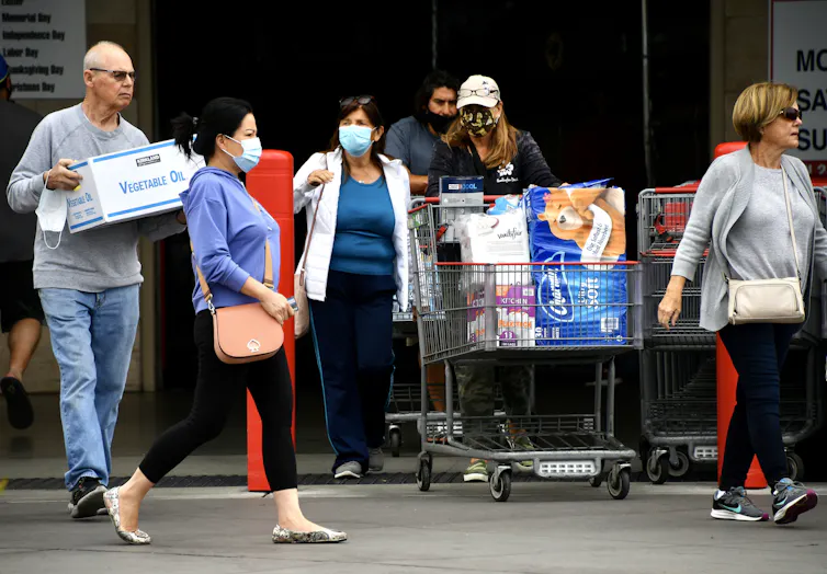 shoppers mostly all wearing masks