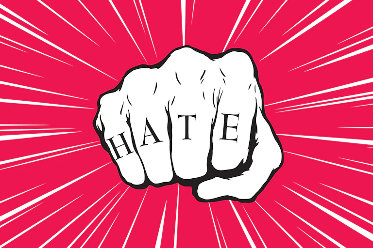 Ilustración de puño con las letras HATE (odio en inglés).