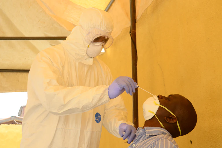 A health worker takes a swab from a man during a community COVID-19 coronavirus testing campaign in Lagos on April 18, 2020.