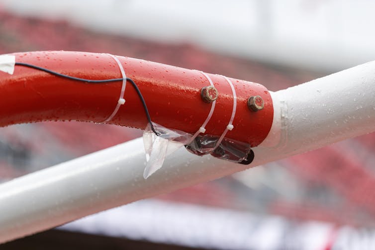 A microphone is taped to a goalpost