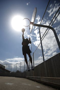 A basketball player jumping to make a shot