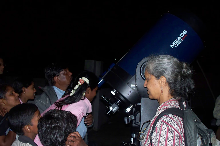 Prajval Shastri shows a telescope to children living in an Indian slum