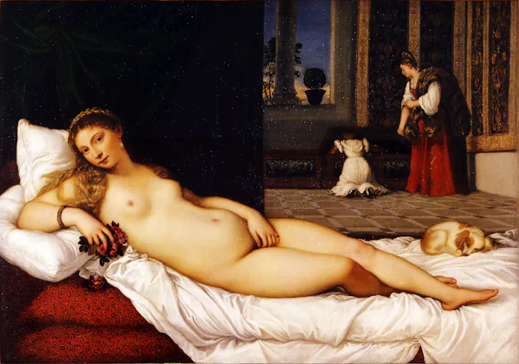 Woman reclines on chaise lounge naked.