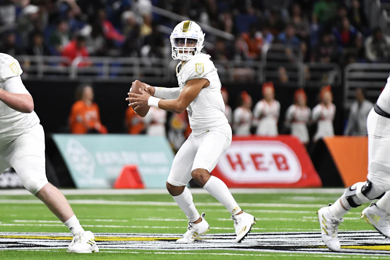 A football player prepares to throw a ball.