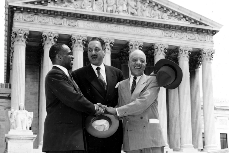 Thurgood Marshall, center, and two other men stand in a 1954 photo on the steps of the U.S. Supreme Court