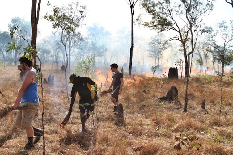 Michael-Shawn Fletcher burning with his students and Otto Campion Bulmaniya.
