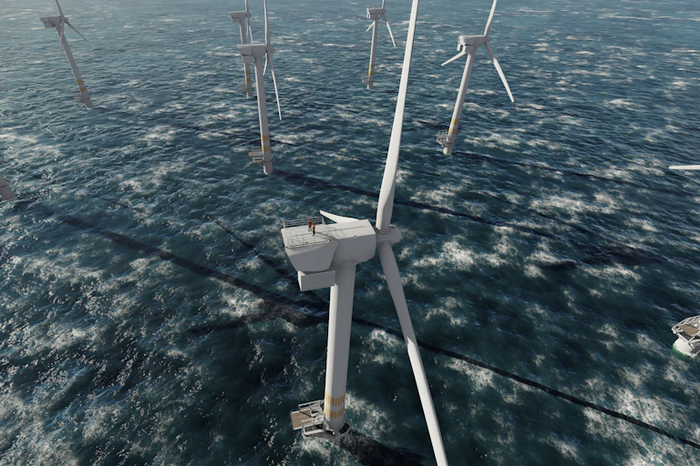 Offshore wind turbines with workers standing atop one.