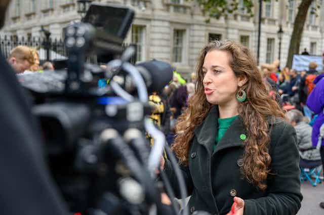 Dr Emily Grossman being interviewed outside Downing Street at an Extinction Rebellion protest.