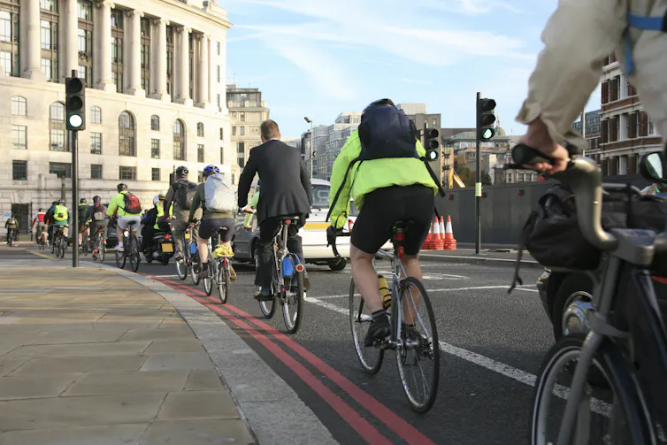 Commuters cycling to work in London