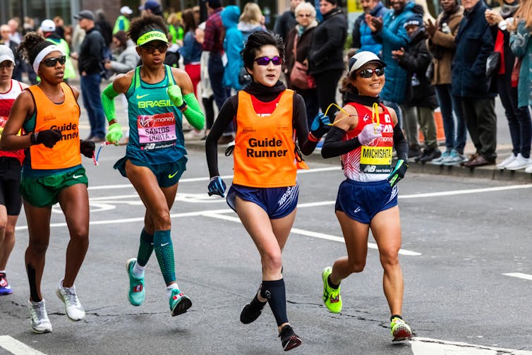 Sight-impaired marathon runners race with their guides