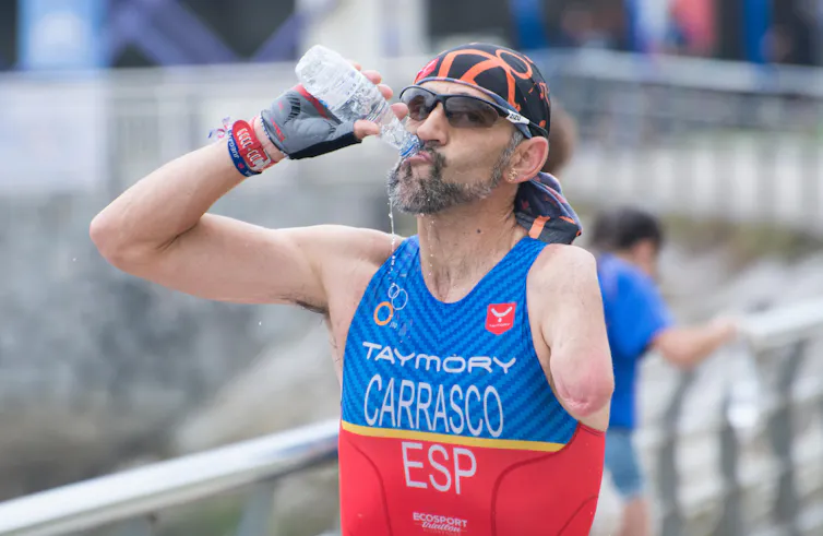 A parathlete rehydrates during a race