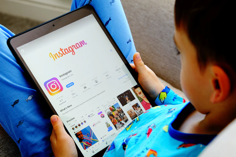 Small child looking at Instagram on an iPad