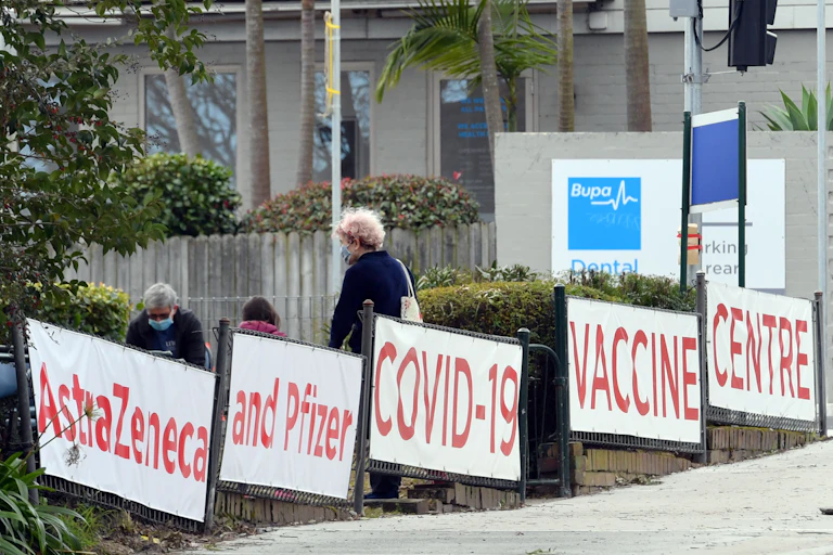 Signs reading "Astrazeneca and Pfizer COVID-19 VACCINE CENTRE"